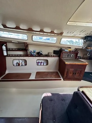 Slide: The Image of Interior of 1983 Catalina 30 Tall Rig sailboat with wooden cabinetry and storage compartments. - 16