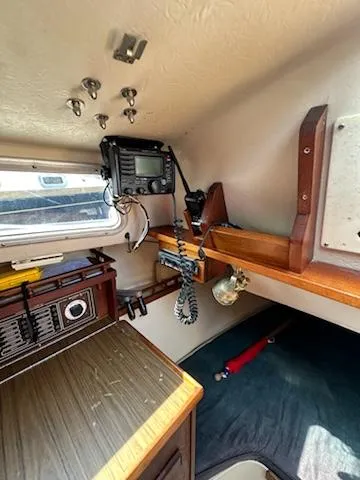 Slide: The Image of Interior of 1983 Catalina 30 Tall Rig sailboat with radio equipment and cozy sleeping area. - 19