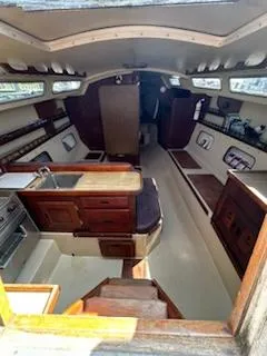 Slide: The Image of Interior of 1983 Catalina 30 Tall Rig sailboat, featuring kitchen and seating area. - 2