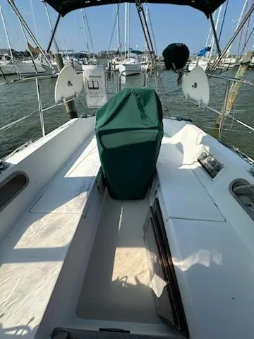 Slide: The Image of 1983 Catalina 30 Tall Rig sailboat cockpit with green cover, docked in a marina. - 20