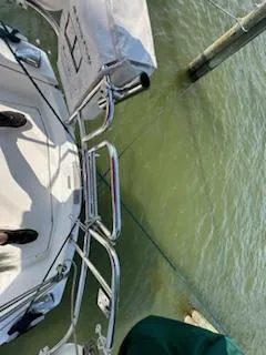 Slide: The Image of 1983 Catalina 30 Tall Rig sailboat docked, view of deck and railing over water. - 22