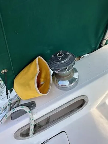 Slide: The Image of 1983 Catalina 30 Tall Rig sailboat deck with winch and yellow cover. - 26