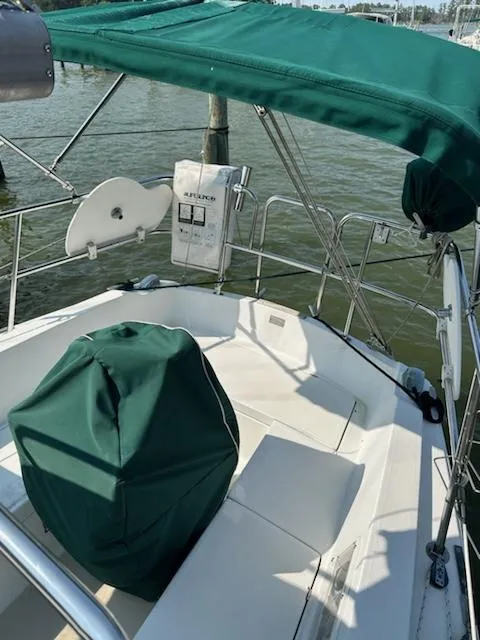 Slide: The Image of 1983 Catalina 30 Tall Rig sailboat cockpit with green canopy and covered seating. - 29