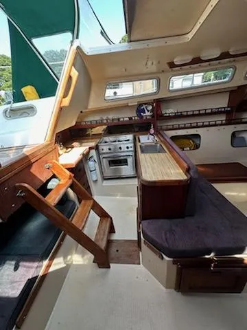 Slide: The Image of Interior of 1983 Catalina 30 Tall Rig sailboat with kitchen and seating area. - 3