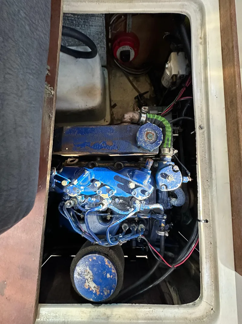 Slide: The Image of Engine compartment of a 1983 Catalina 30 Tall Rig sailboat, featuring a blue engine. - 32