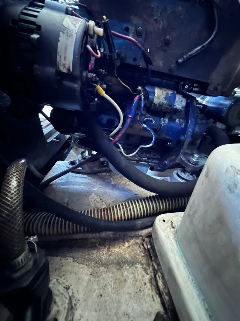 Slide: The Image of Engine compartment of a 1983 Catalina 30 Tall Rig sailboat, showcasing wiring and components. - 33