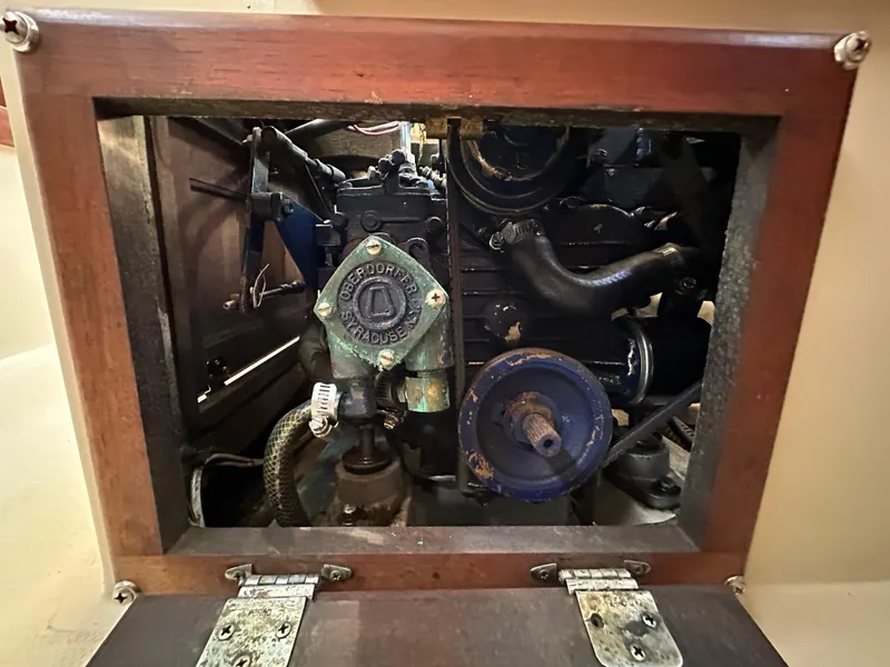 Slide: The Image of Engine compartment of a 1983 Catalina 30 Tall Rig sailboat, featuring mechanical components. - 35