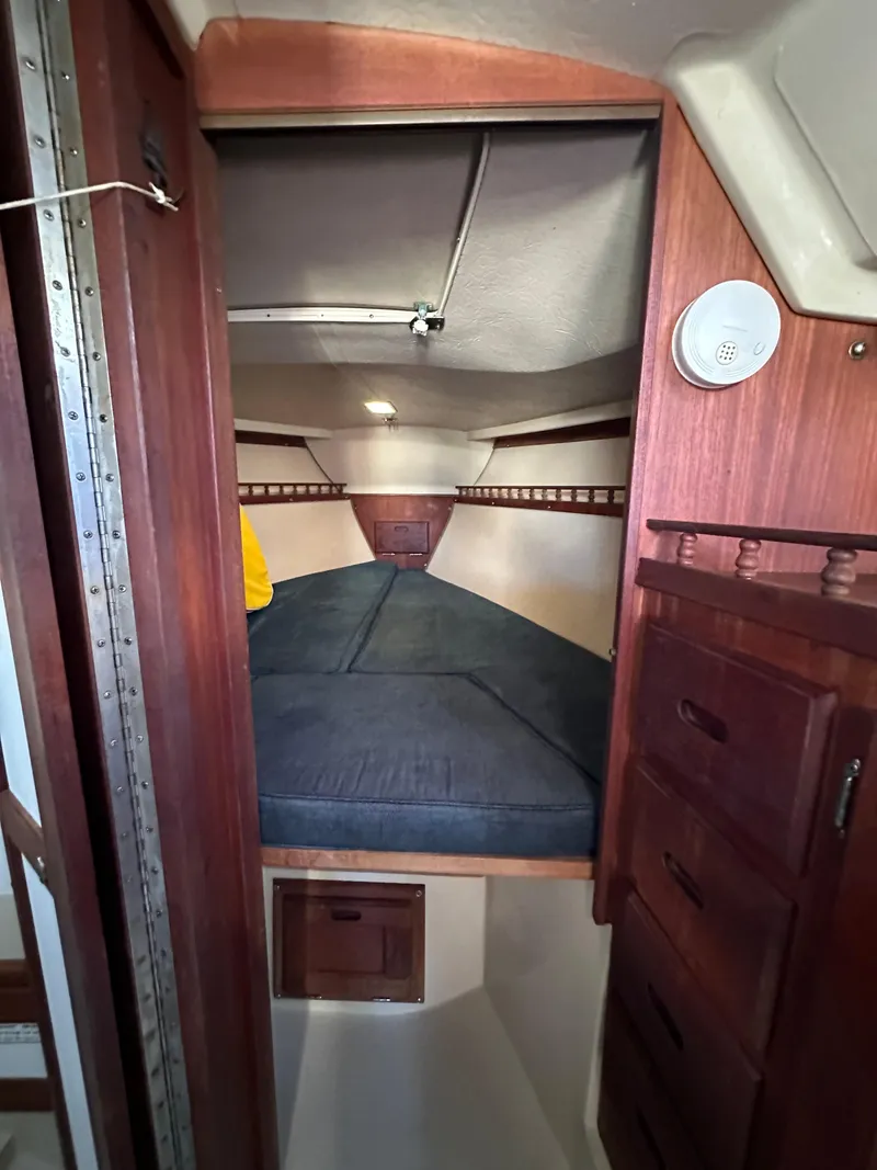 Slide: The Image of Interior cabin of a 1983 Catalina 30 Tall Rig sailboat with wooden furnishings. - 36