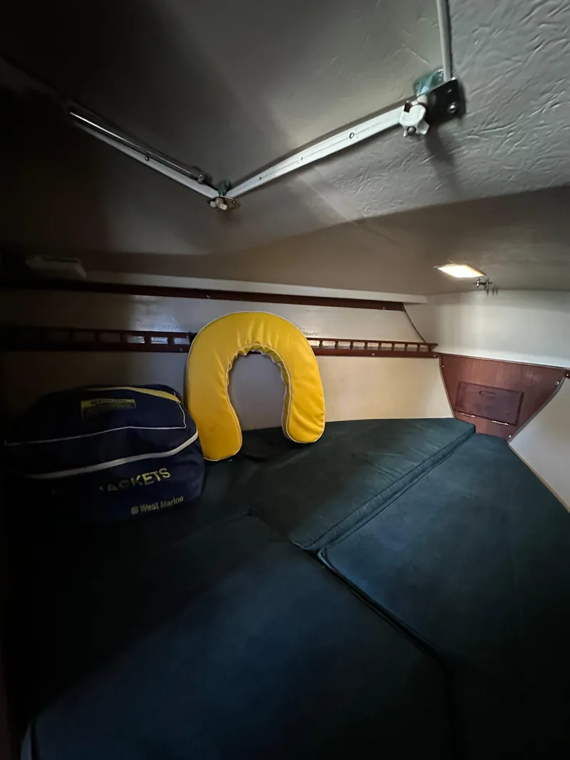 Slide: The Image of Cozy cabin interior of 1983 Catalina 30 Tall Rig sailboat with cushions and life jacket. - 38