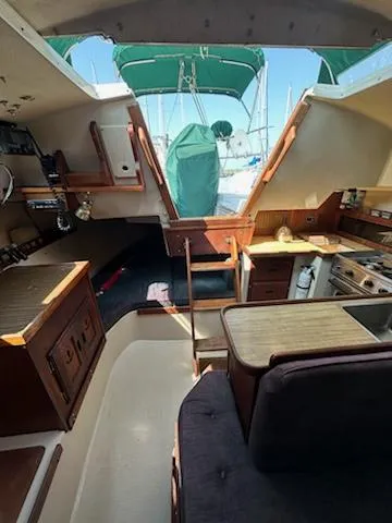 Slide: The Image of Interior of 1983 Catalina 30 Tall Rig sailboat with kitchen and seating area. - 4