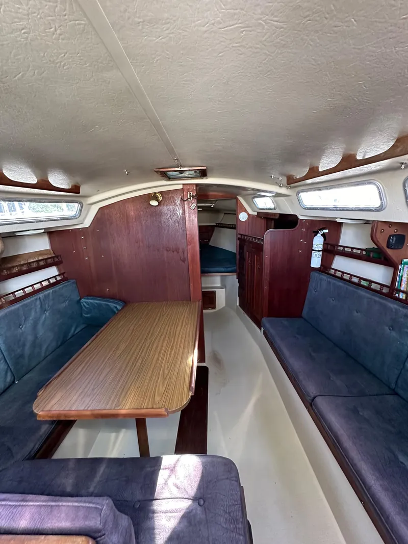 Slide: The Image of Interior of 1983 Catalina 30 Tall Rig sailboat with seating and table. - 41