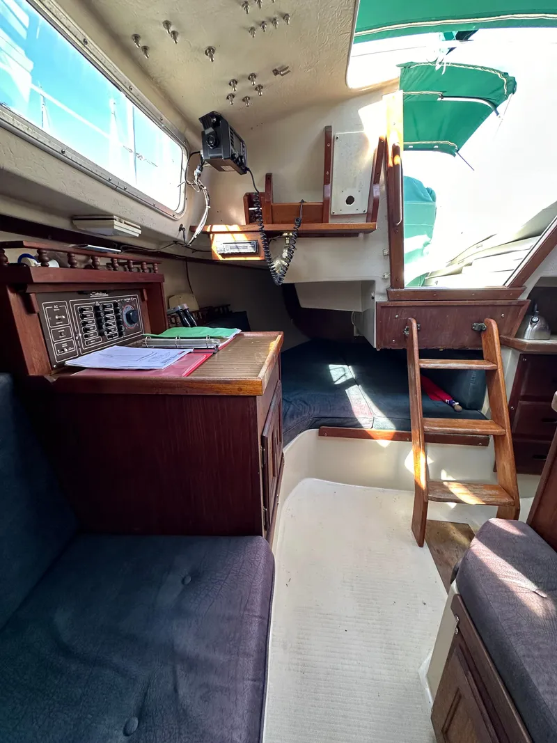 Slide: The Image of Interior of 1983 Catalina 30 Tall Rig sailboat with wooden furnishings and navigation station. - 46