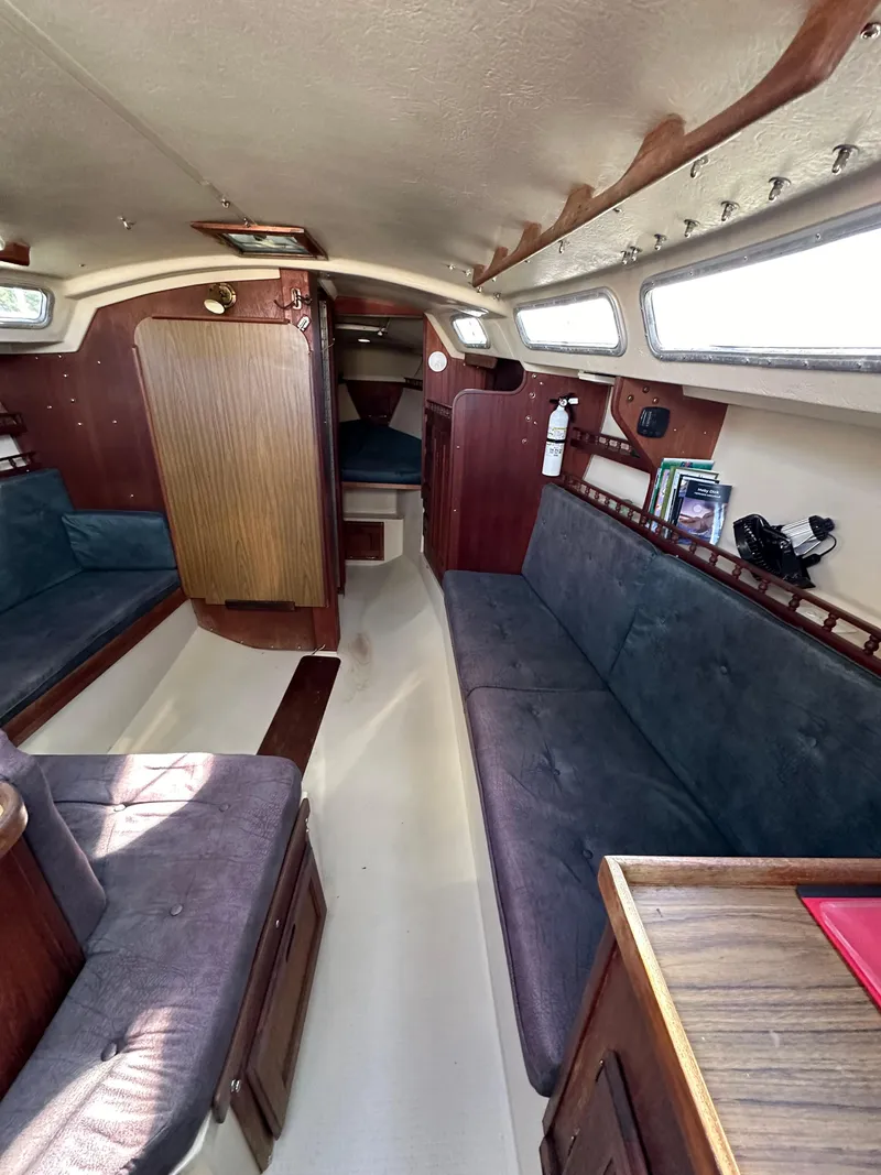 Slide: The Image of Interior of a 1983 Catalina 30 Tall Rig sailboat with cozy seating and wooden accents. - 48