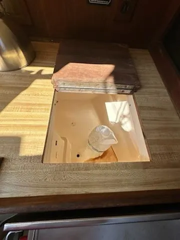 Slide: The Image of 1983 Catalina 30 Tall Rig interior with wooden countertop and built-in sink. - 7