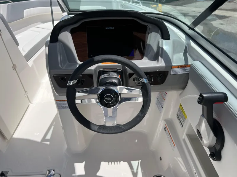 Slide: The Image of 2024 Chaparral 23 SSi OB boat cockpit with steering wheel and control panel. - 10