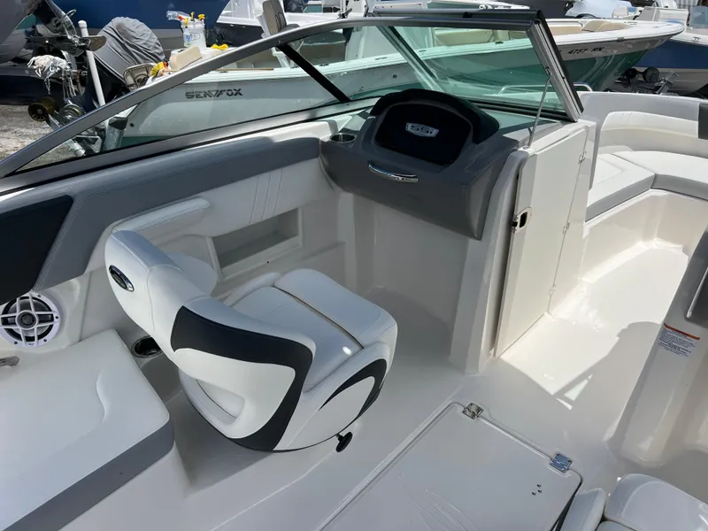 Slide: The Image of 2024 Chaparral 23 SSi OB boat interior with captain's chair and dashboard. - 13