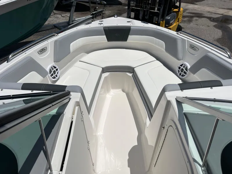 Slide: The Image of 2024 Chaparral 23 SSi OB boat interior with white seating and speakers. - 14