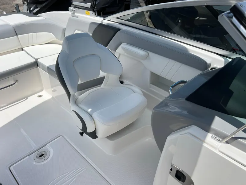 Slide: The Image of 2024 Chaparral 23 SSi OB boat interior with white seating and modern design. - 18