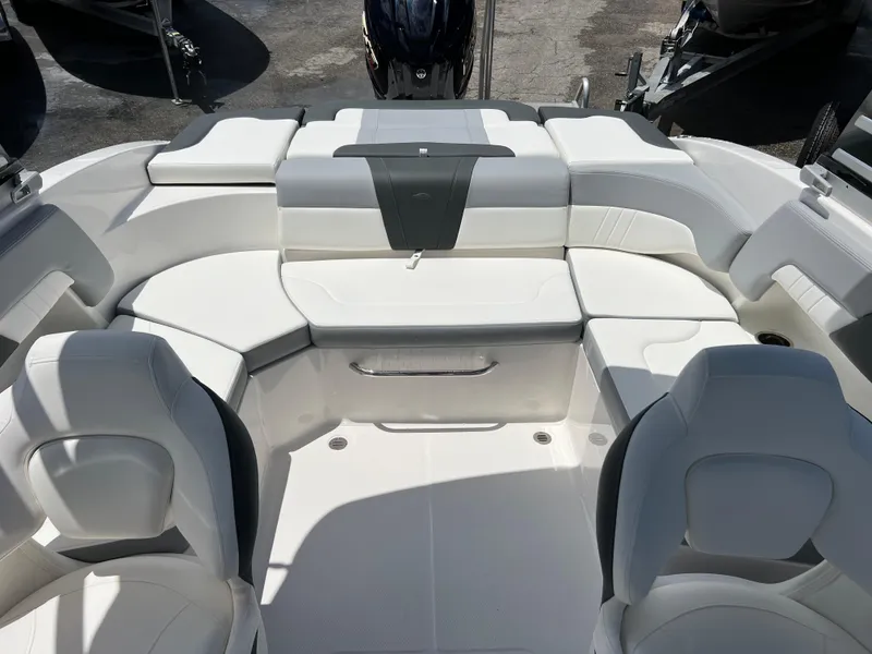 Slide: The Image of 2024 Chaparral 23 SSi OB boat interior with white seating and modern design. - 19