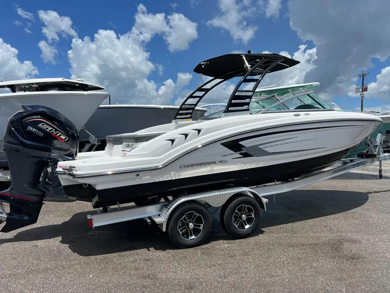 Slide: The Image of 2024 Chaparral 23 SSi OB boat on a trailer under a blue sky. - 2