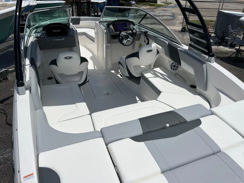Slide: The Image of 2024 Chaparral 23 SSi OB boat interior with white and gray seating. - 8
