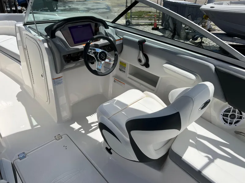 Slide: The Image of 2024 Chaparral 23 SSi OB boat interior with steering wheel and captain's chair. - 9