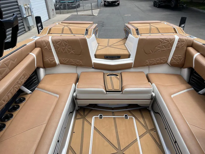 Slide: The Image of 2024 Nautique Super Air Nautique G25 Paragon interior with tan and white seating. - 10