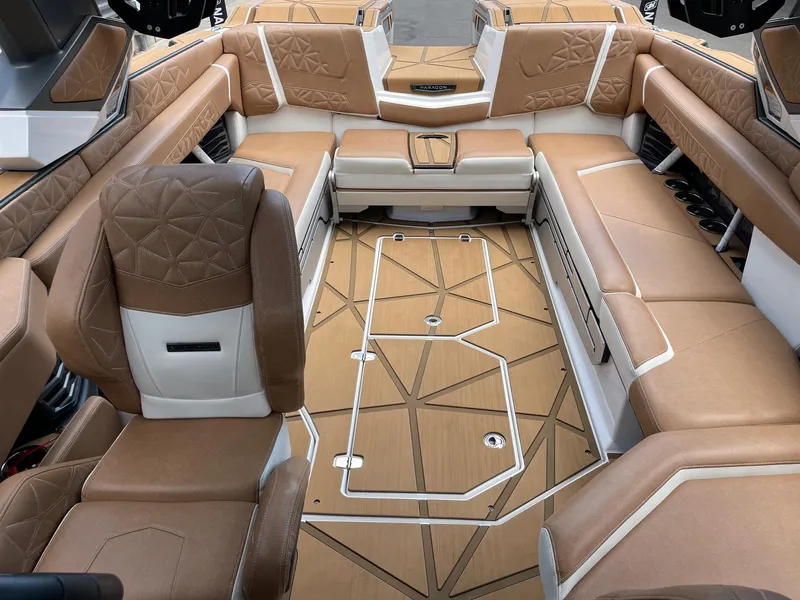 Slide: The Image of 2024 Nautique Super Air Nautique G25 Paragon interior with luxurious tan seating and geometric flooring. - 14