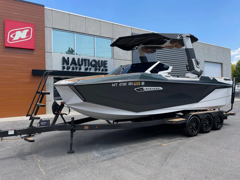 Slide: The Image of 2024 Nautique Super Air Nautique G25 Paragon boat on trailer outside dealership. - 3