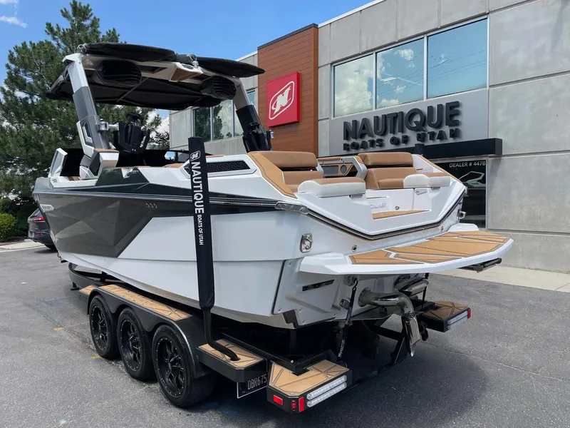 Slide: The Image of 2024 Nautique Super Air Nautique G25 Paragon boat on trailer outside dealership. - 4
