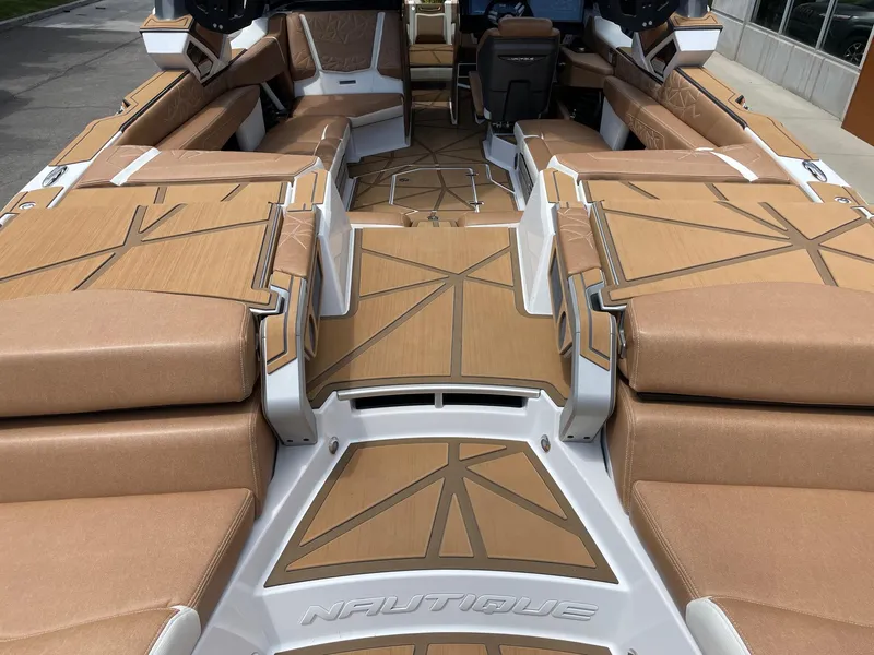 Slide: The Image of 2024 Nautique Super Air Nautique G25 Paragon interior with tan upholstery and spacious seating. - 6