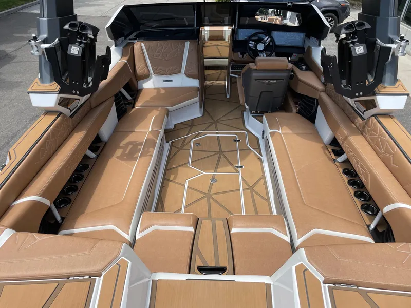 Slide: The Image of 2024 Nautique Super Air Nautique G25 Paragon interior with luxurious tan seating. - 7
