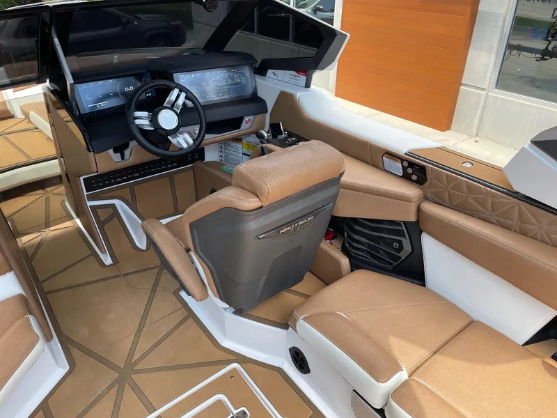 Slide: The Image of 2024 Nautique Super Air Nautique G25 Paragon interior with luxurious seating and advanced dashboard. - 8