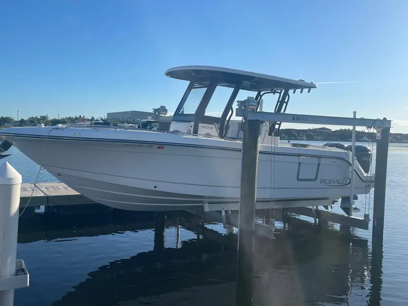 The Image of 2022 Robalo R272 Center Console boat docked on a lift. - 0