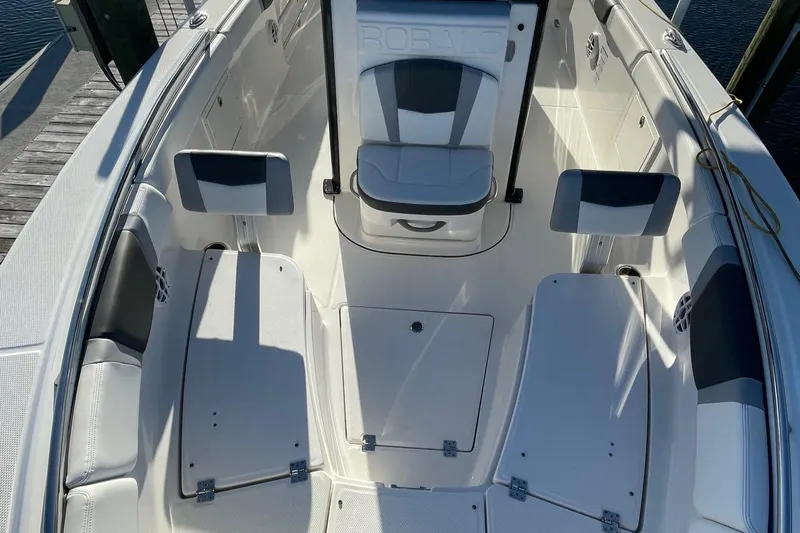 Slide: The Image of 2022 Robalo R272 Center Console boat interior with seating and storage compartments. - 13