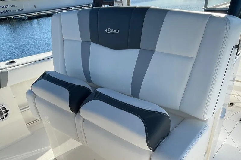 Slide: The Image of 2022 Robalo R272 Center Console boat seating with gray and white upholstery. - 15