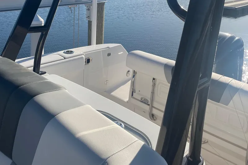Slide: The Image of 2022 Robalo R272 Center Console boat interior with seating and water view. - 16