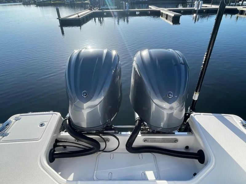 Slide: The Image of 2022 Robalo R272 Center Console twin outboard engines at dock. - 3