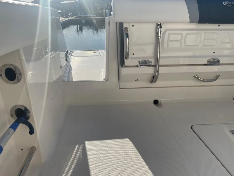 Slide: The Image of 2022 Robalo R272 Center Console boat interior with seating and storage compartments. - 6