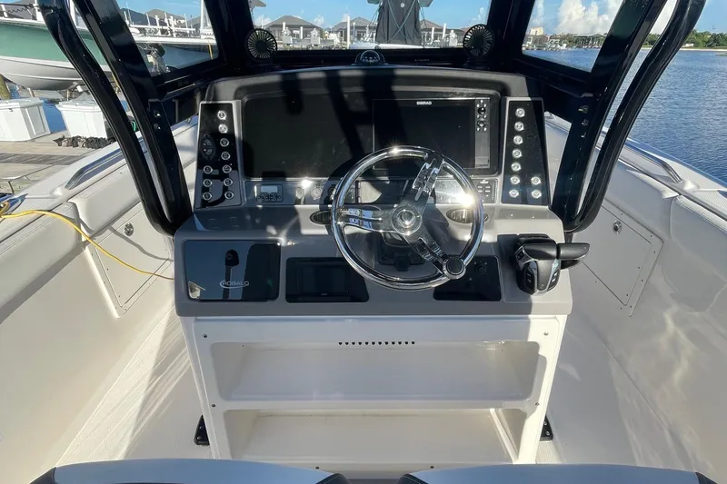 Slide: The Image of 2022 Robalo R272 Center Console boat helm with modern controls and navigation system. - 9