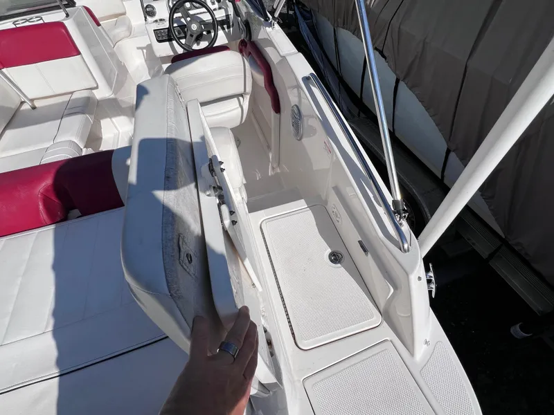 Slide: The Image of 2016 Bayliner 195 Deck Boat interior with white and red seating. - 12