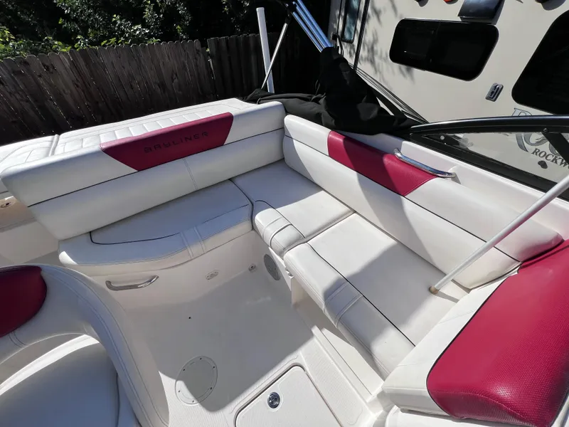 Slide: The Image of 2016 Bayliner 195 Deck Boat interior with white and red seating. - 14