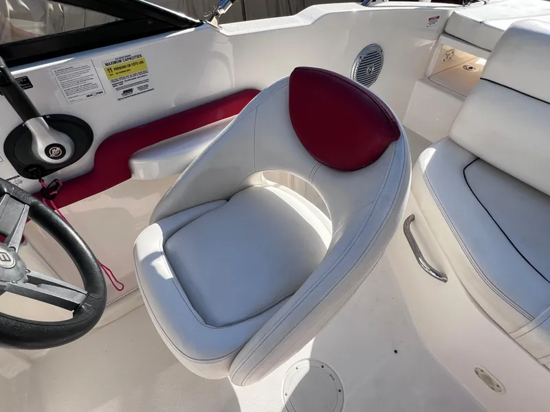 Slide: The Image of 2016 Bayliner 195 Deck Boat interior with white and red seating. - 15