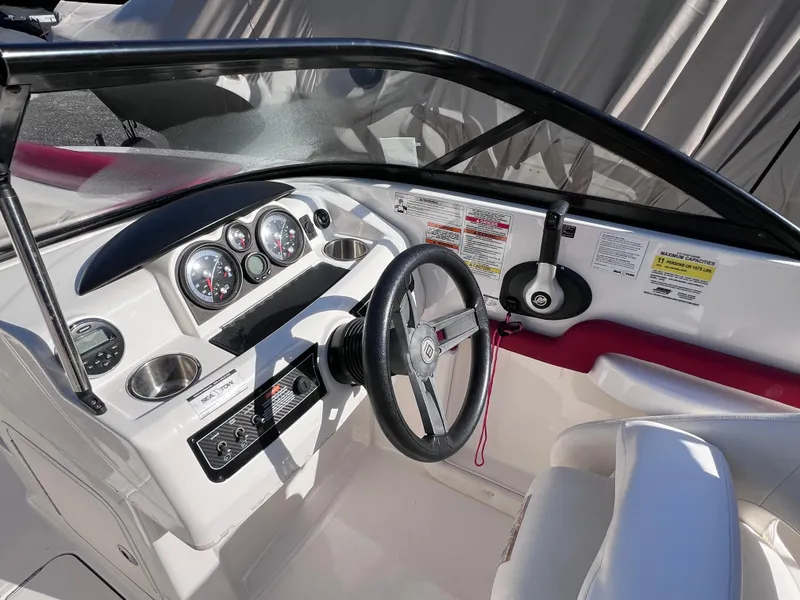 Slide: The Image of 2016 Bayliner 195 Deck Boat cockpit with steering wheel and instrument panel. - 17