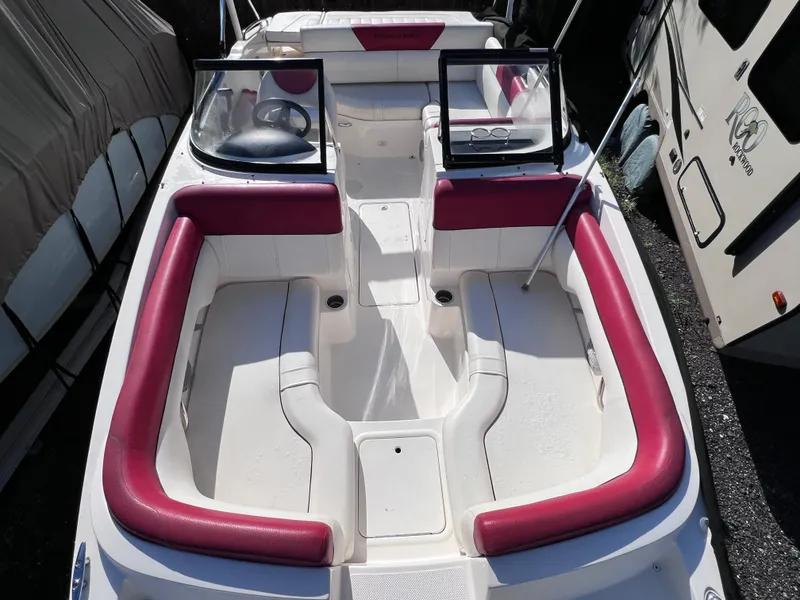 Slide: The Image of 2016 Bayliner 195 Deck Boat with red and white seating, docked. - 21