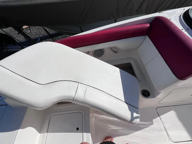 Slide: The Image of 2016 Bayliner 195 Deck Boat interior seating with white and red upholstery. - 23