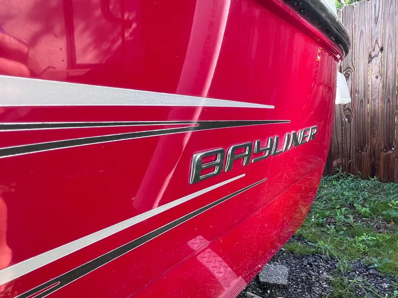 Slide: The Image of 2016 Bayliner 195 Deck Boat, red exterior with white stripes, close-up view. - 5
