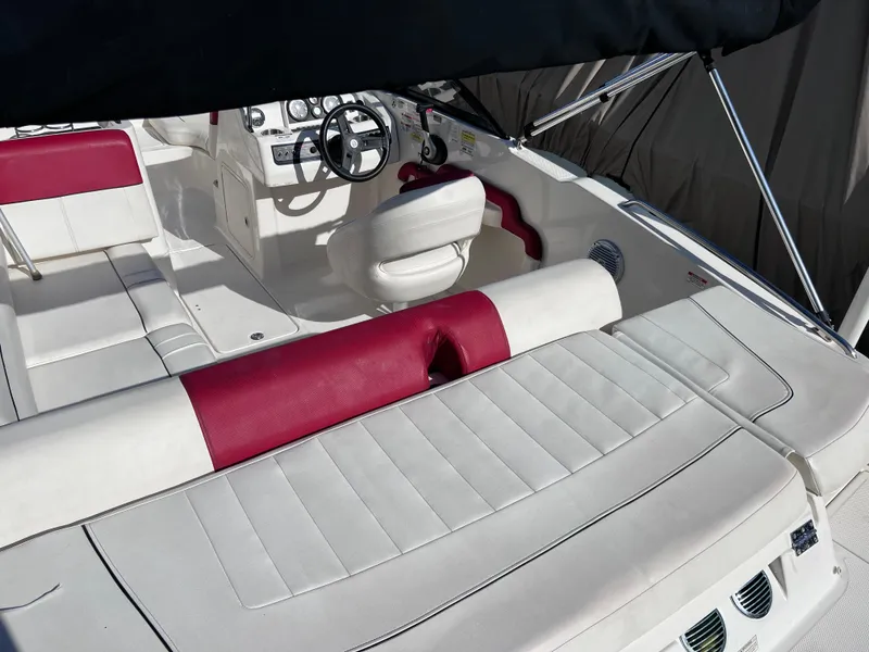 Slide: The Image of 2016 Bayliner 195 Deck Boat interior with white and red seating. - 8