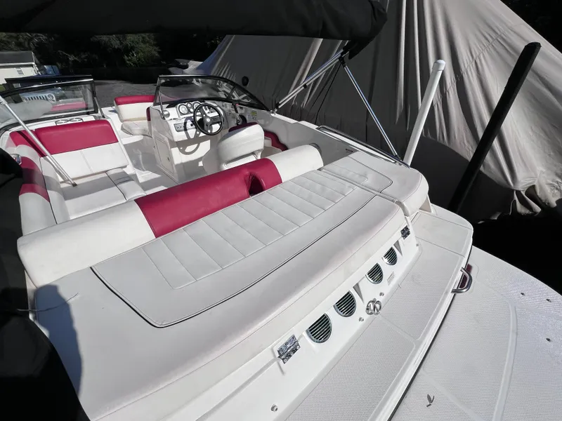 Slide: The Image of 2016 Bayliner 195 Deck Boat with white and red interior, docked and covered. - 9