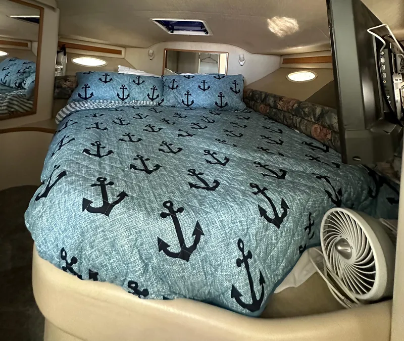 Slide: The Image of 1996 Sea Ray 370 Sedan Bridge cabin with anchor-themed bedding. - 15